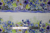 Flat swatch Floral Stripe fabric (white fabric with large striped clusters of floral design in blue, purple, green shades with floral heads, leaves and paisley look design)