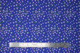 Flat swatch daisies blue fabric (royal blue fabric with small tossed white daisies allover with dark orange centers and tiny green stems)