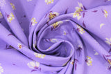 Swirled swatch lilies and dandelions purple fabric (pale purple fabric with tossed white and purple small lilies and dandelions allover)