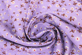 Swirled swatch daisies purple fabric (pale purple fabric with small tossed white daisies allover with dark orange centers and brown/maroon coloured stems)