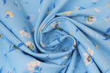 Swirled swatch lilies and dandelions blue fabric (light blue fabric with small tossed white and blue lilies and dandelions allover)
