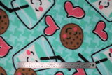 Flat swatch cookies and milk fabric (light green/blue fabric with lighter green/blue organic star shape pattern repeated and large tossed cartoon graphics of smiling milk glasses with black straws and smiling brown chocolate chip cookies and tossed pink hearts with thick black outlines)