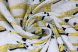 Swirled swatch giraffes fabric (white fabric with mint polka dots and repeated illustrative style yellow and brown giraffes)