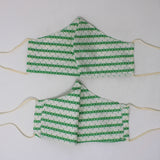 Front and back view of ninja style mask with off white elastic ear loops (white mask with horizontal green stripes and wisps of colour dragging up and down slightly)