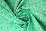 Swirled swatch Green Flowers fabric (green fabric with tossed thin wispy floral stems and heads in white and green shades)