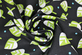 Swirled swatch leaves fabric (black fabric with tossed green and white cartoon style leaves with blue polka dots)