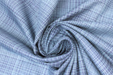Swirled swatch hey mister fabric (dark blue fabric with medium blue diagonally crossing lines allover)