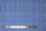 Flat swatch let them be little fabric (deep blue fabric with thin white stripes with scalloped cloud-like shape tops)