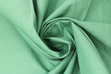 Swirled swatch of cotton solid in green medium