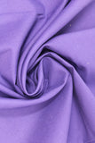 Swirled swatch of cotton solid in violet (dark purple)
