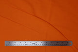 Flat swatch of cotton solid in neon orange