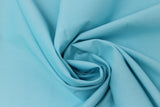 Swirled swatch of cotton solid in cornflower blue (bright light blue)