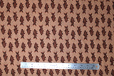 Flat swatch fish print fabric in brown (tan coloured fabric with brown coloured alternating fish pattern lines)