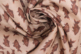 Swirled swatch fish print fabric in brown (tan coloured fabric with brown coloured alternating fish pattern lines)