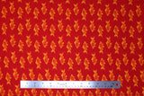Flat swatch fish print fabric in red (red coloured fabric with orange coloured alternating fish pattern lines)