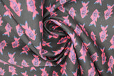 Swirled swatch fish print fabric in black (black coloured fabric with pink/blue coloured alternating fish pattern lines)