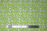 Flat swatch of peony printed fabric in white (white fabric with light green cartoon peony heads tossed)