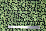 Flat swatch of peony printed fabric in black (black fabric with light green cartoon peony heads tossed)