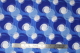 Flat swatch blotches printed fabric in blue (medium blue fabric with light blue, dark blue, and white coloured circular blotches collage)