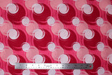 Flat swatch blotches printed fabric in pink (medium pink fabric with light pink, dark pink/red, and white coloured circular blotches collage)