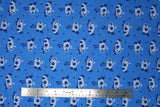 Flat swatch cartoon chicks printed fabric in blue (medium blue fabric with occasional dark blue polka dots and blue cartoon baby chickens tossed allover)