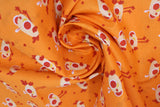 Swirled swatch cartoon chicks printed fabric in orange (bright orange fabric with occasional dark orange/red polka dots and white/orange cartoon baby chickens tossed allover)