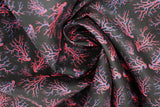 Swirled swatch lightning printed fabric in black (black fabric with pink and blue squiggly lightning bolt look print tossed allover)
