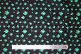 Flat swatch crystals printed fabric in black (black fabric with tossed cartoon crystal clusters in light blue/green shades)