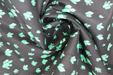 Swirled swatch crystals printed fabric in black (black fabric with tossed cartoon crystal clusters in light blue/green shades)