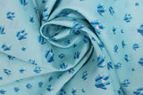Swirled swatch crystals printed fabric in blue (light blue fabric with tossed cartoon crystal clusters in blue shades)