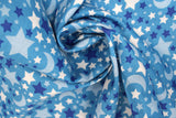 Swirled swatch small stars and moons printed fabric in grey (blue fabric with tossed stars and moons allover in various shades of blue and white)
