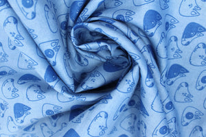 Group swatch of puppy heads printed fabric in black and blue