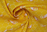 Swirled swatch cartoon fish and scales printed fabric in yellow (yellow fabric with white scale/scalloped pattern with tossed white and yellow/orange coy style fish)