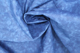 Swirled swatch of blue fabric in shadow (medium blue marbled fabric)