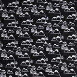 Square swatch of mountain cabins printed fabric in black (black fabric with tossed white cartoon mountains and cabin print repeated)