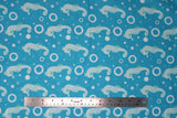 Flat swatch of sea life fabric in seahorses (blue) (bright blue fabric with tossed white sea houses and circles/bubbles)
