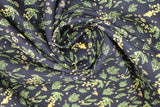 Swirled swatch of sea life fabric in green aquatic plants (black fabric with tossed green and yellow sea greenery/plants and bubbles)