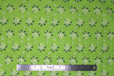 Flat swatch of sea life fabric in octopus (green) (lime green fabric with tossed white shining stars, and pale green octopi small)