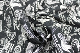 Swirled swatch of assorted Friday the 13th pattern on black (black fabric with multi emblems tossed in black and white. Crossing checkered flags, 13 badges, "Port Dover Motorcycle Rally" text, wheels, etc.)