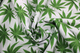 Swirled swatch of pot leaf print fabric on white