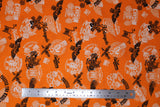 Flat swatch of assorted Canadian custom motorcycles fabric in orange (orange fabric with tossed logo and text related to Canadian custom motorcycles "Custom" text, etc. in white, black)
