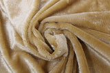 Swirled swatch of faux fur fabric in light brown