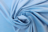 Swirled swatch of faux fur fabric in light blue