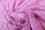 Swirled swatch of faux fur fabric in light pink