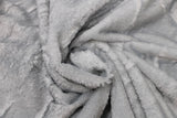 Swirled swatch of faux fur fabric in grey