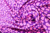 Swirled swatch of faux fur fabric in pink/purple print (purple fabric with pink stone like pattern allover)