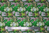 Flat swatch Lucky Puppies fabric (green fabric with busy collaged cartoon/drawn style dogs in various breeds with clover accents: in mouths or on fur, etc.)