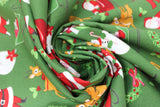 Swirled swatch Christmas printed fabric in Santa and Sleigh on Green