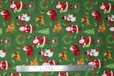 Flat swatch Christmas printed fabric in Santa and Sleigh on Green