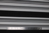 Flat swatch onyx stripe fabric (white fabric with thick black stripes and groups of small black stripes within the white spaces)